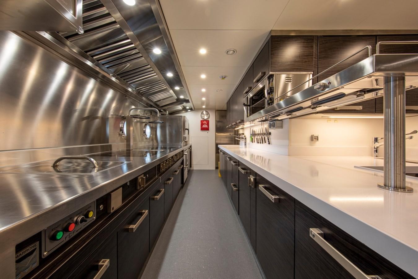 a kitchen with stainless steel appliances aboard AUDACE Yacht for Sale