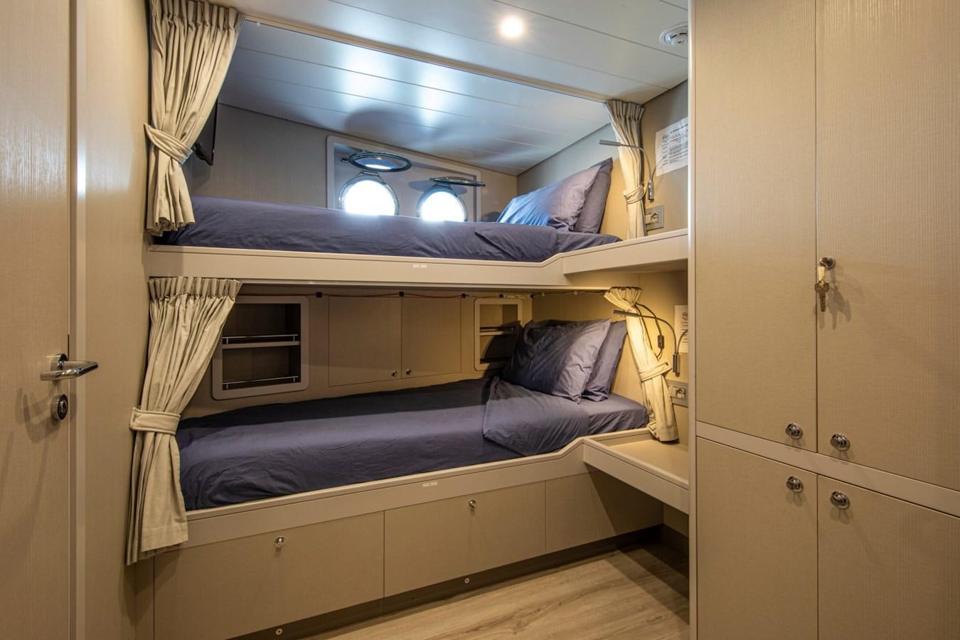 a room with a bed and a closet aboard AUDACE Yacht for Sale