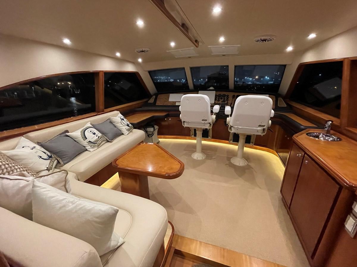 a room with a couch and a table and chairs aboard REEL BUSY Yacht for Sale