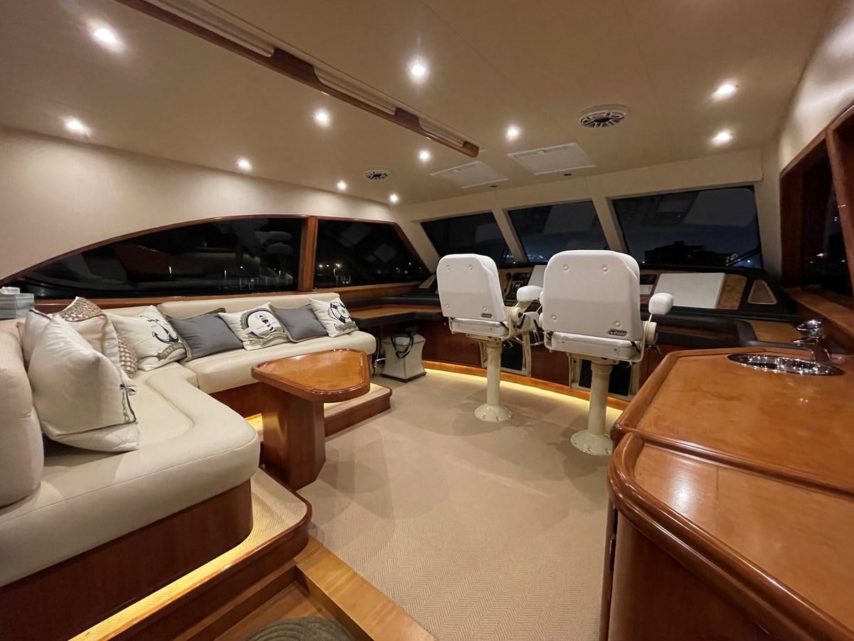 a room with a couch and a table and chairs aboard REEL BUSY Yacht for Sale