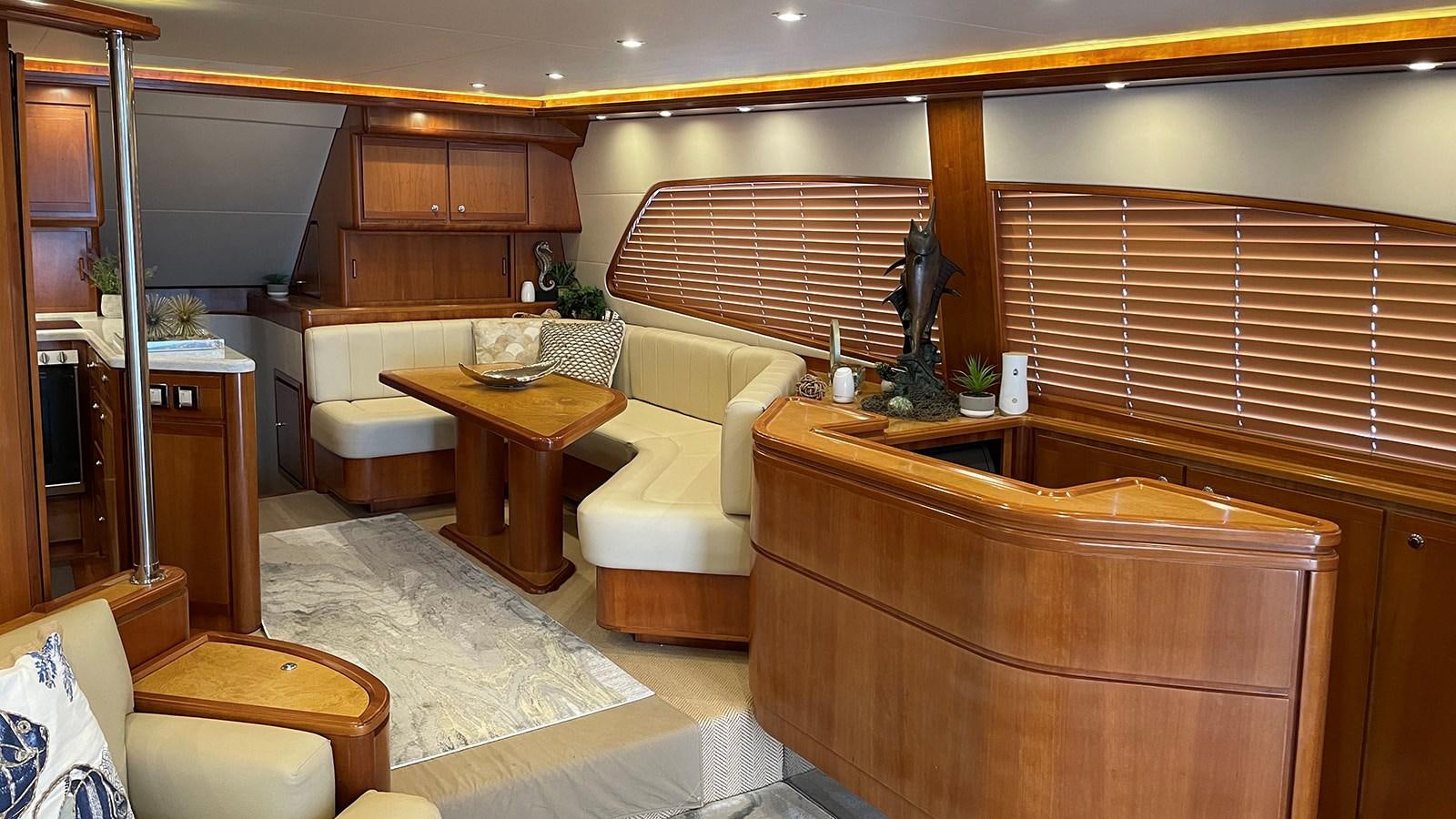 a living room with a couch and a table aboard REEL BUSY Yacht for Sale