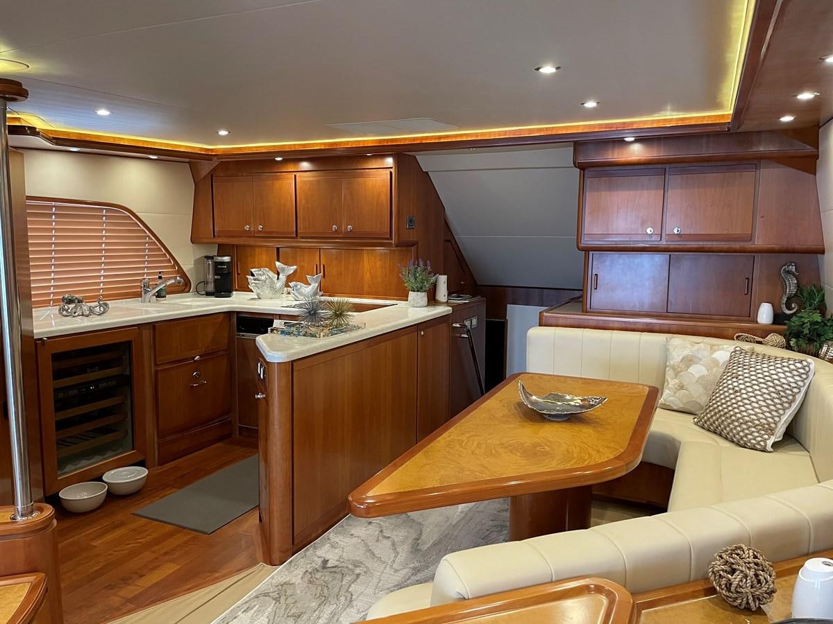 a kitchen with a table and couch aboard REEL BUSY Yacht for Sale