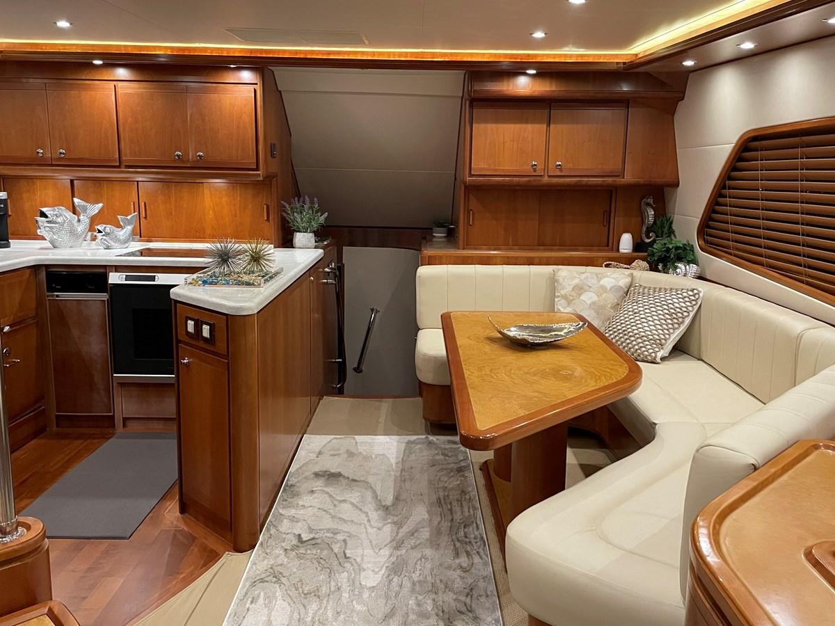 a kitchen with wooden cabinets aboard REEL BUSY Yacht for Sale
