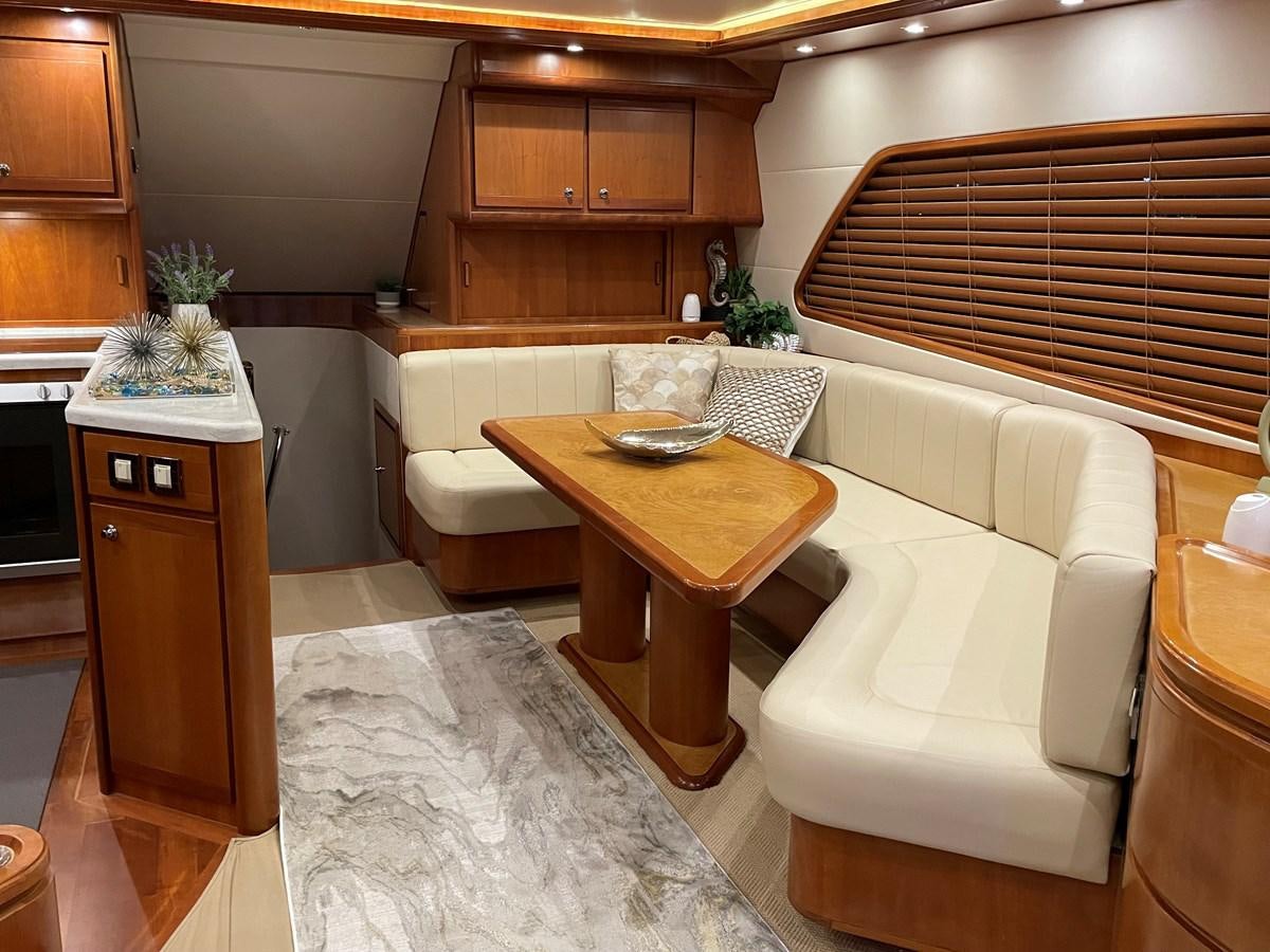 a living room with a table and chairs aboard REEL BUSY Yacht for Sale