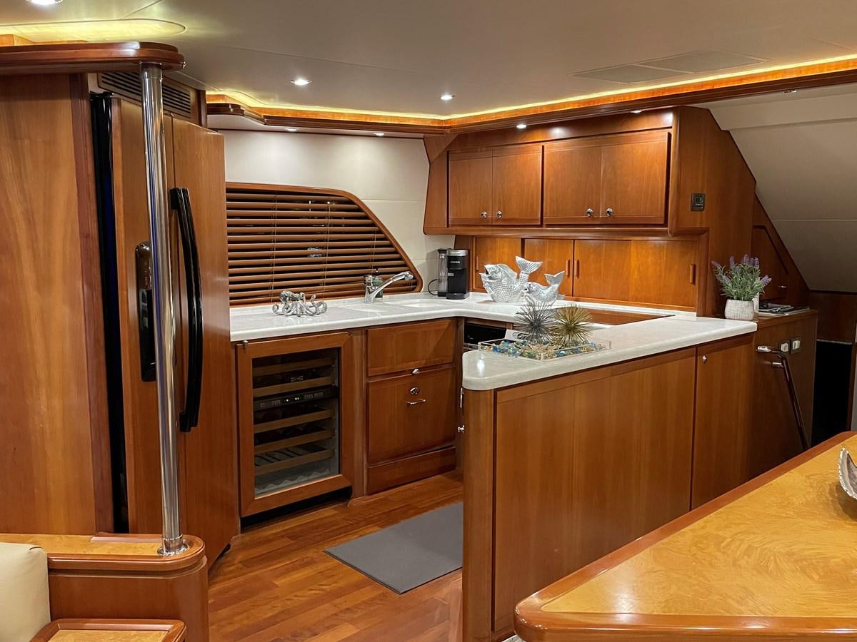 a kitchen with wooden cabinets aboard REEL BUSY Yacht for Sale
