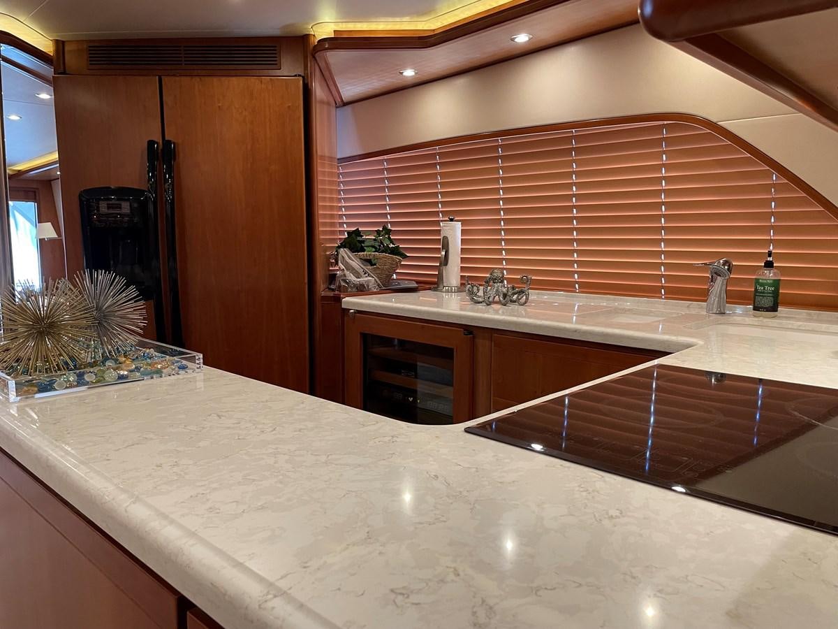 a kitchen with a large island aboard REEL BUSY Yacht for Sale