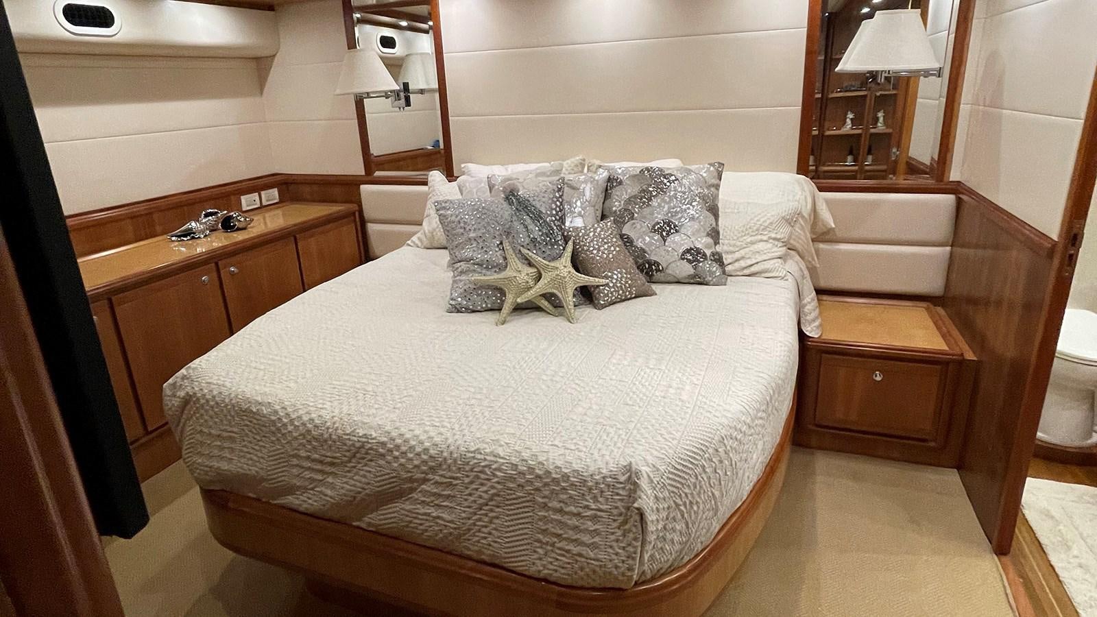 a bed with white sheets and pillows aboard REEL BUSY Yacht for Sale