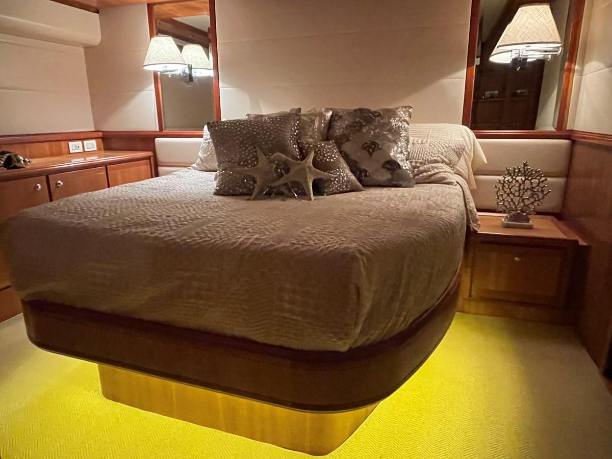 a bed with a large headboard aboard REEL BUSY Yacht for Sale