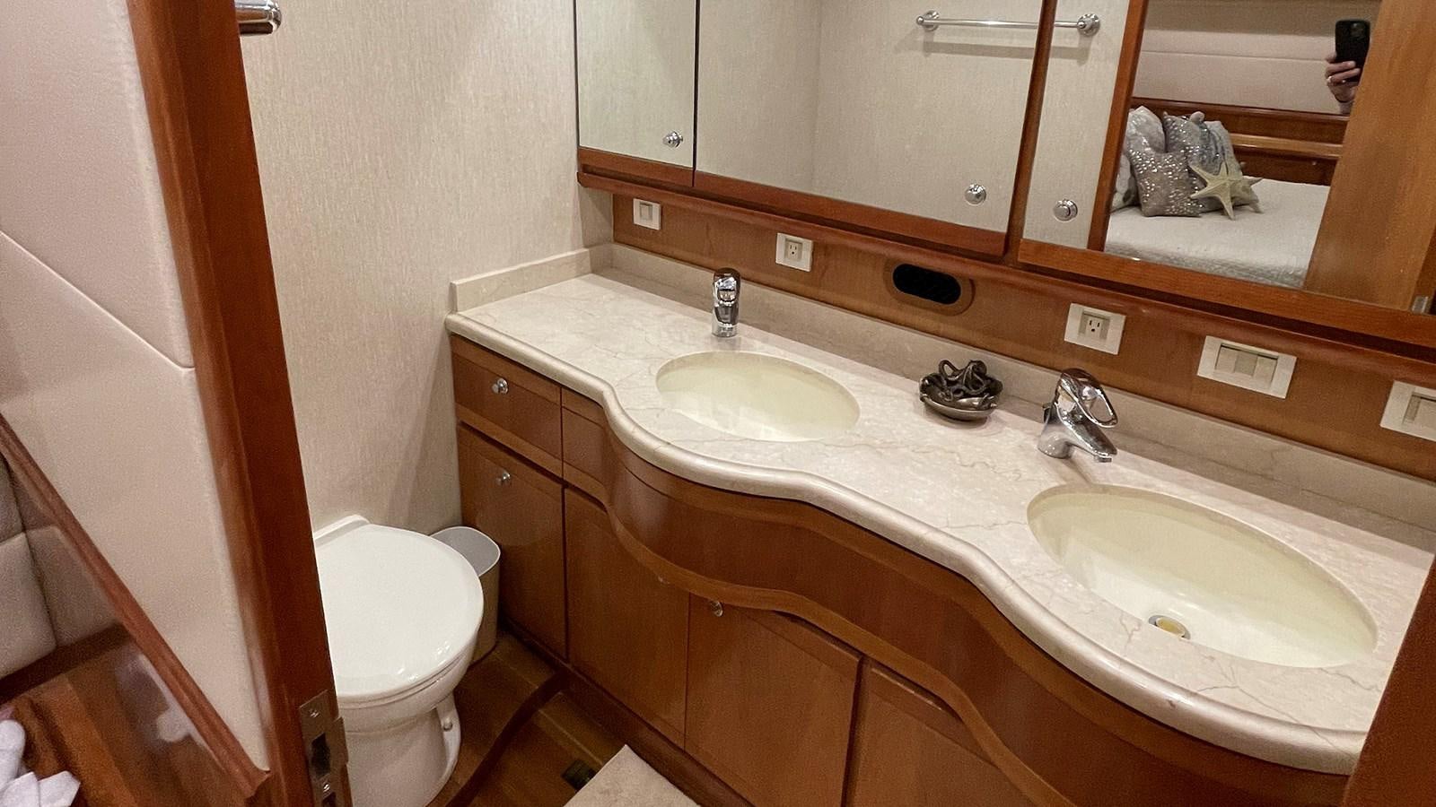 a bathroom with a sink and a toilet aboard REEL BUSY Yacht for Sale