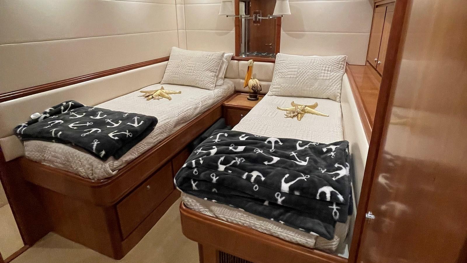 a couple of beds in a room aboard REEL BUSY Yacht for Sale