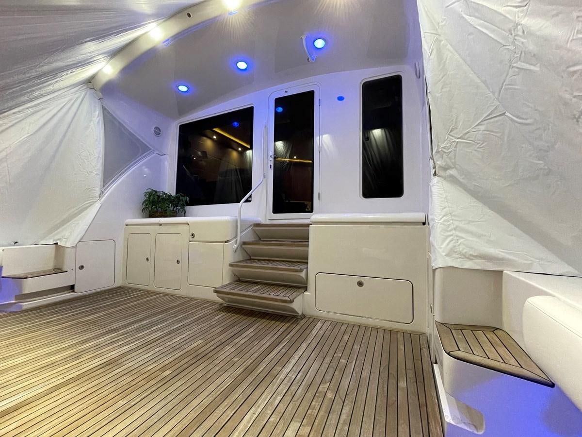 a room with a wood floor and a tv on the wall aboard REEL BUSY Yacht for Sale