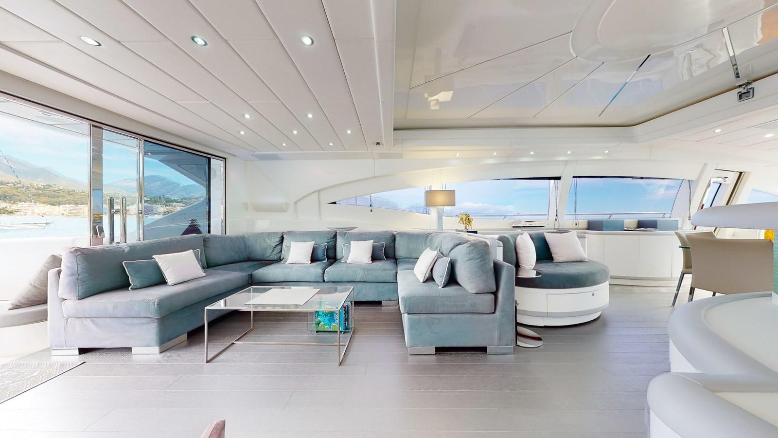 a living room with a blue couch aboard SPLENDIDA Yacht for Sale