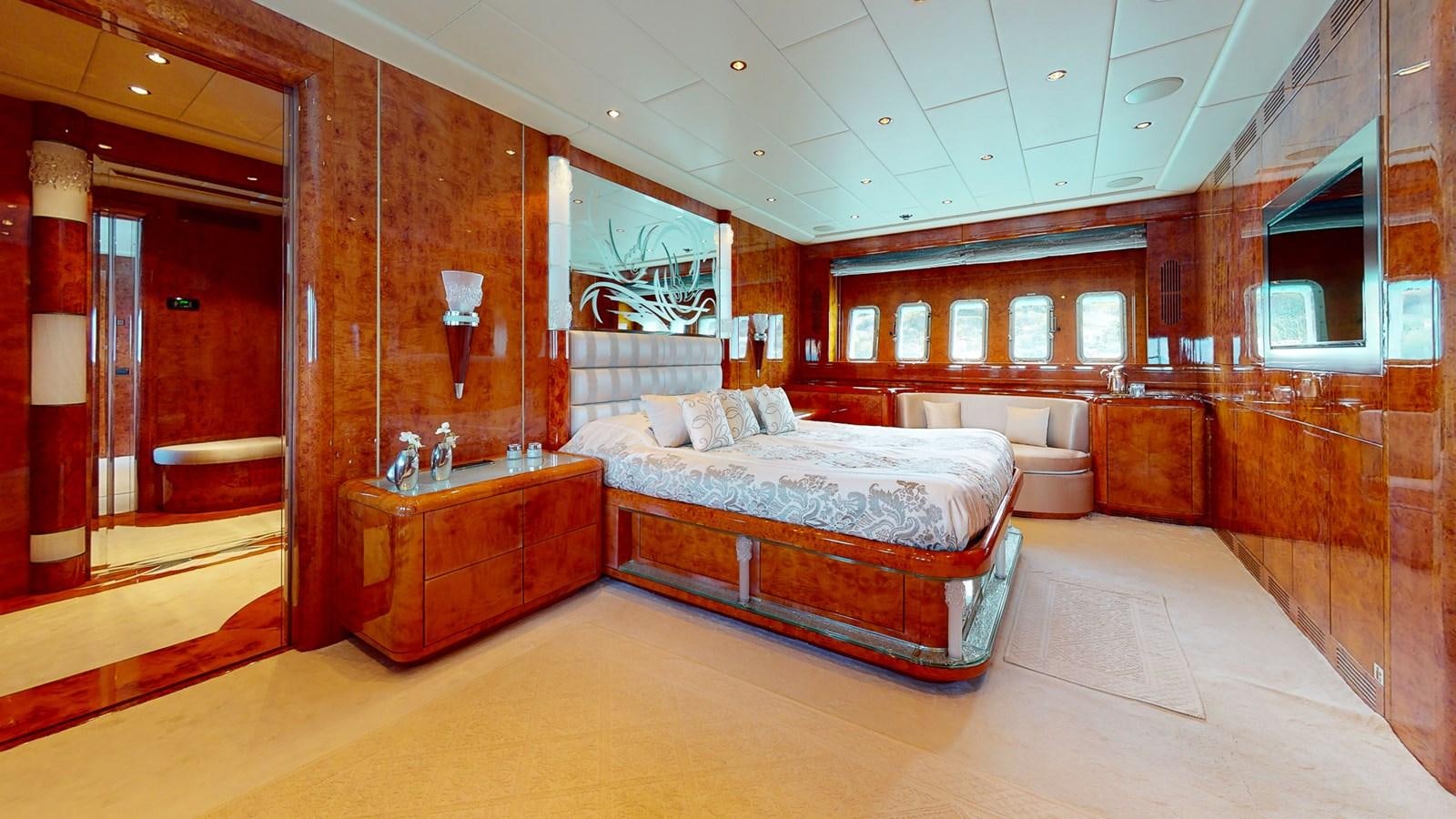 a room with a bed and a mirror aboard SPLENDIDA Yacht for Sale