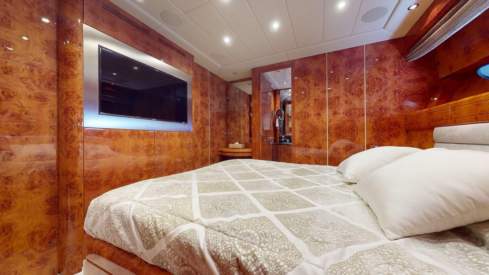 a bed with a television on the wall aboard SPLENDIDA Yacht for Sale