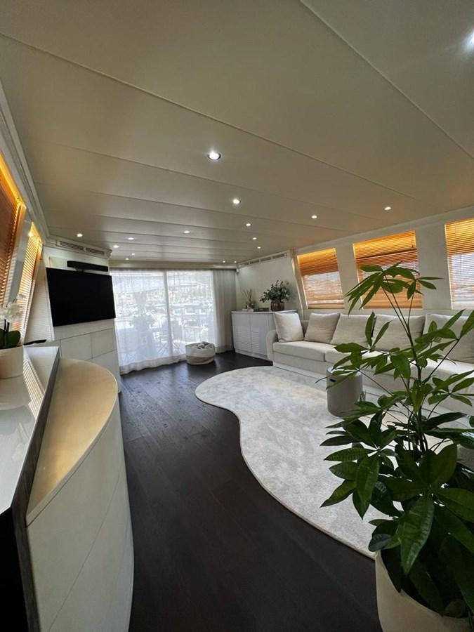 a room with a couch and a plant in it aboard DEAONE Yacht for Sale