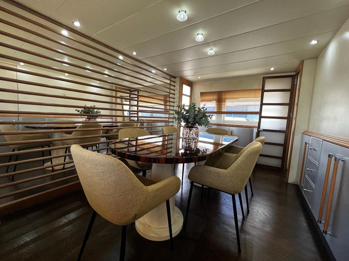 a room with a table and chairs aboard DEAONE Yacht for Sale