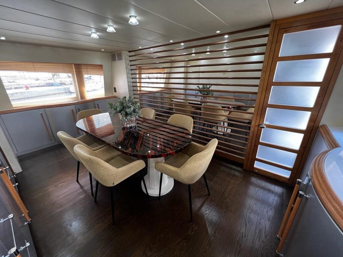 a room with a table and chairs aboard DEAONE Yacht for Sale