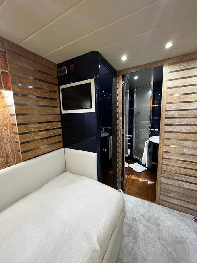 a room with a bed and a television aboard DEAONE Yacht for Sale