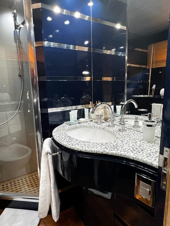 a bathroom with a sink and a large mirror aboard DEAONE Yacht for Sale