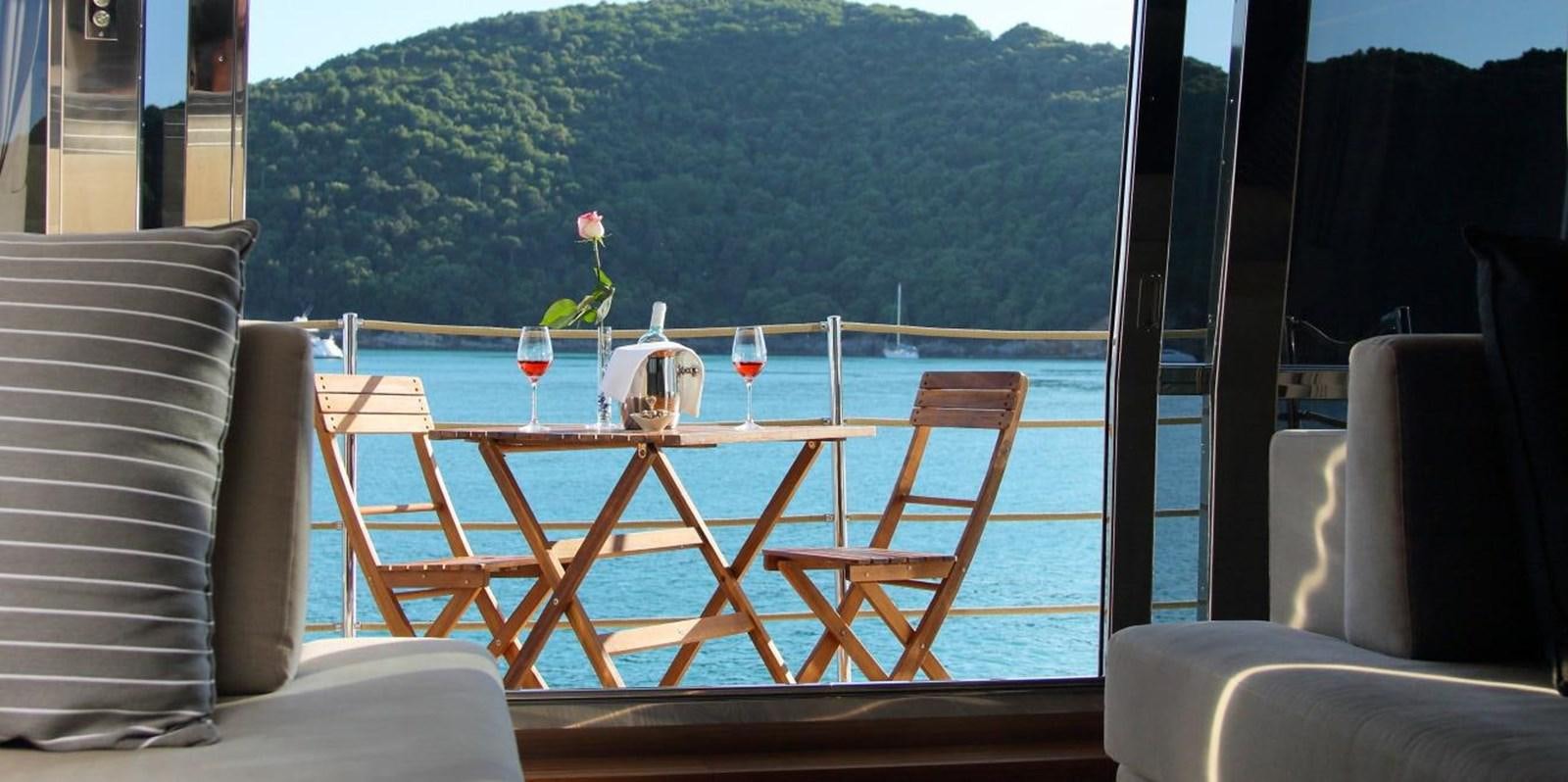a table with glasses on it aboard VELA Yacht for Sale