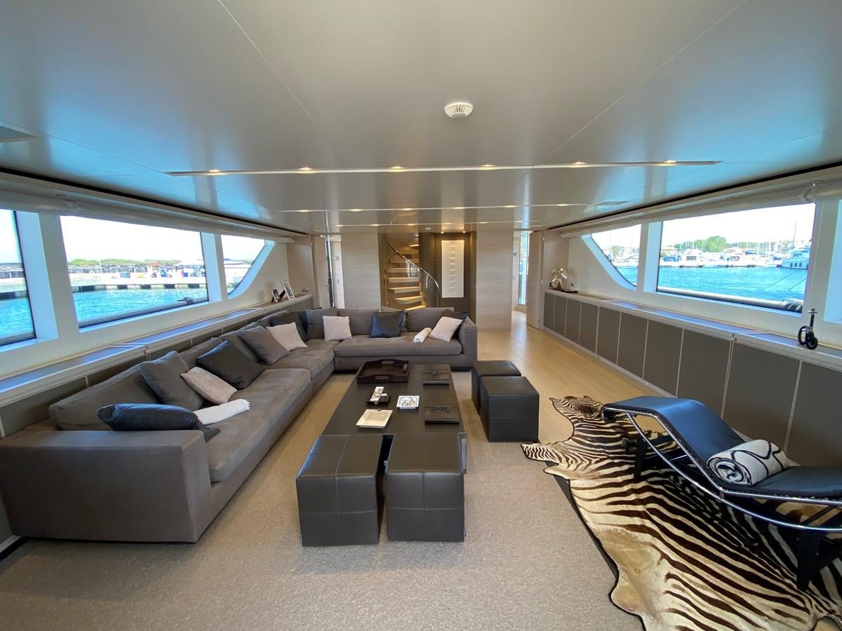 a living room with a couch and a table aboard NAYA 7 Yacht for Sale
