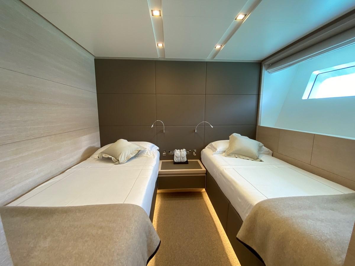 a room with beds and a window aboard NAYA 7 Yacht for Sale