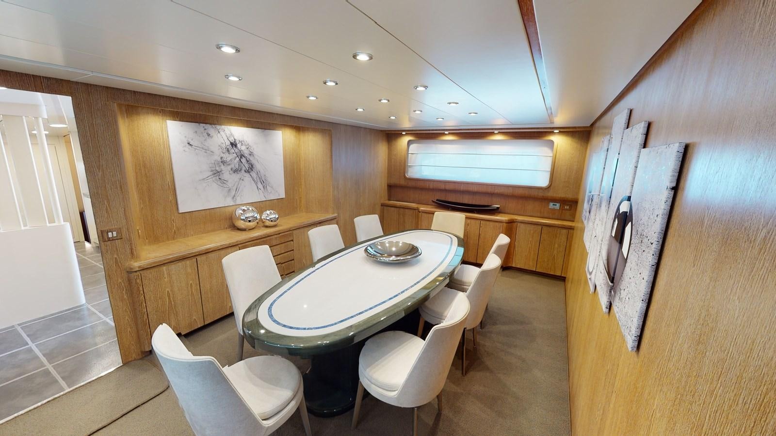 a room with a table and chairs aboard IXIA Yacht for Sale