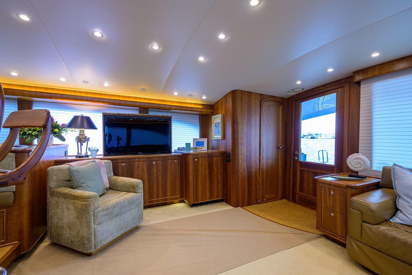 a living room with a wood cabinet and a television aboard GEORGIA GIRL Yacht for Sale