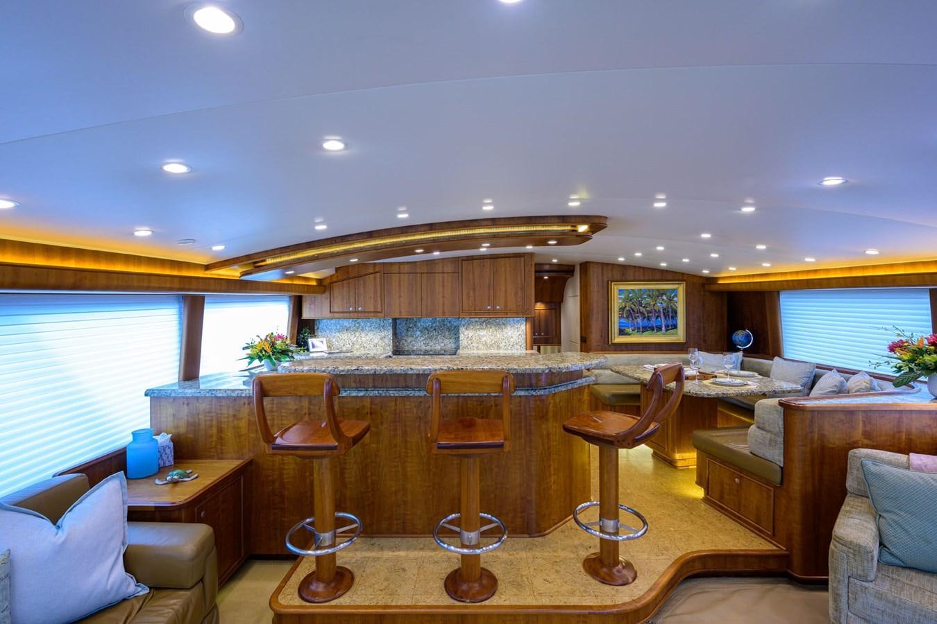 a living room with a large sofa and a wood table aboard GEORGIA GIRL Yacht for Sale