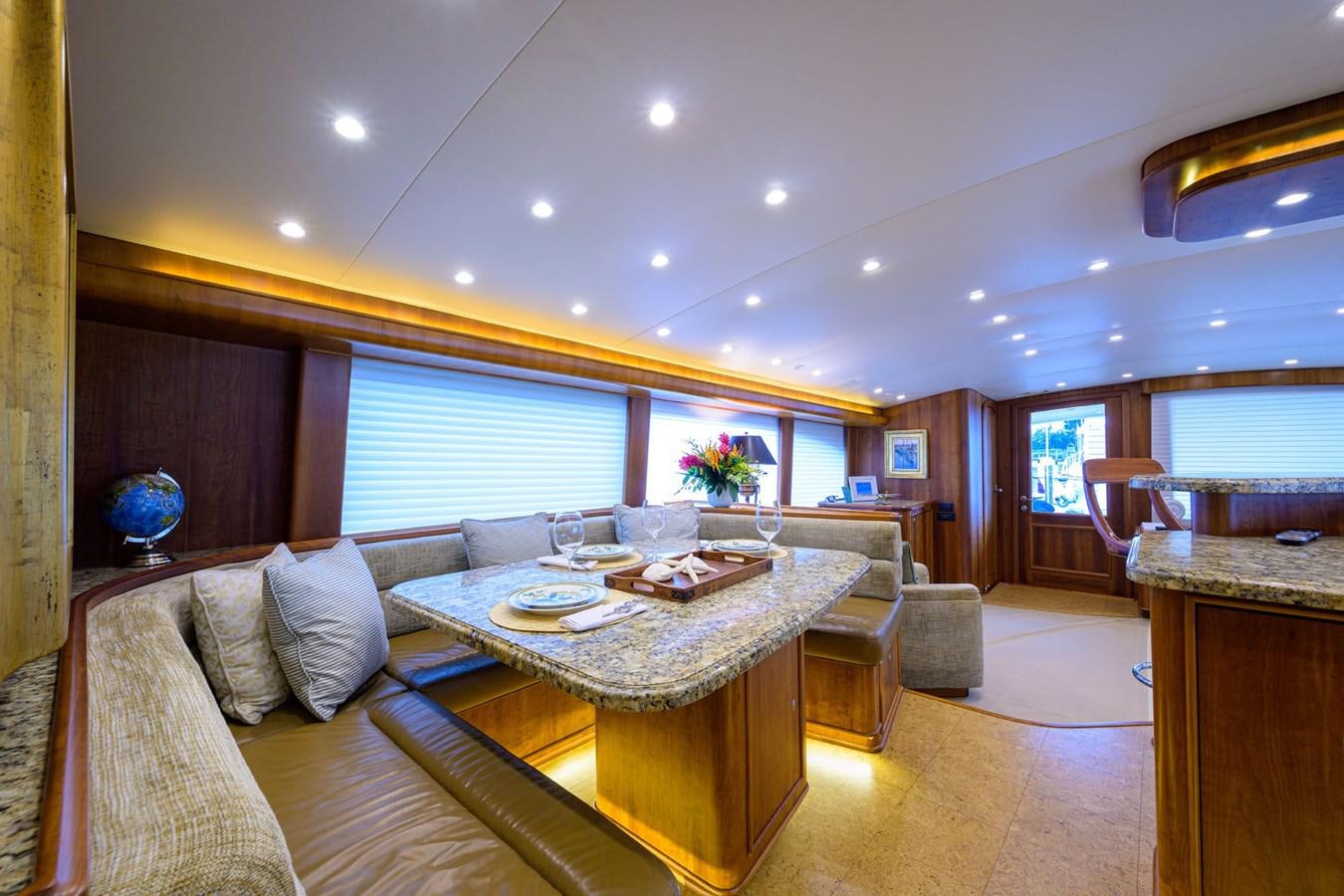a living room with a table and chairs aboard GEORGIA GIRL Yacht for Sale