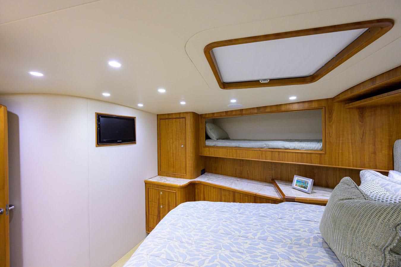 a bedroom with a bed and a television aboard GEORGIA GIRL Yacht for Sale