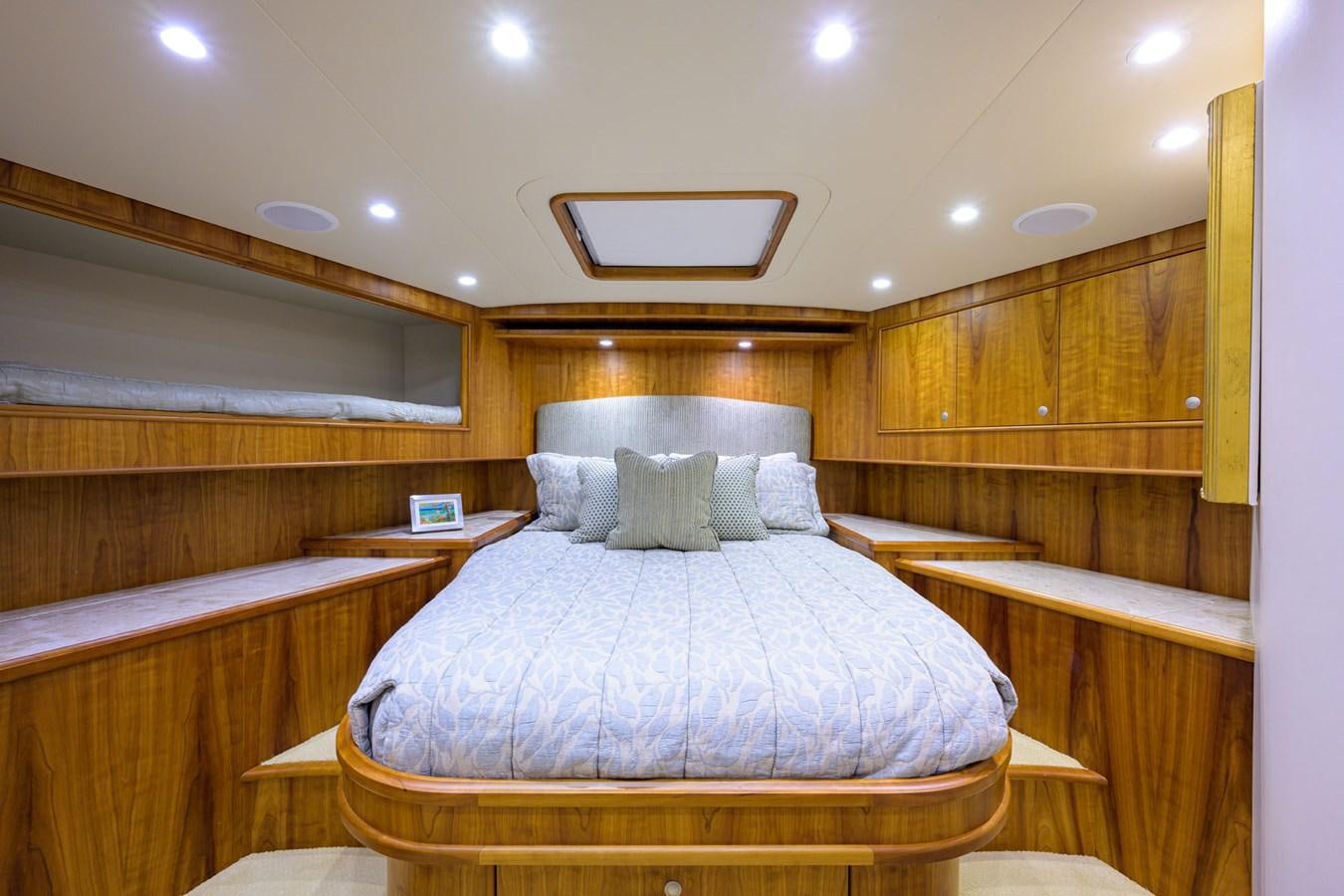 a bed with white sheets aboard GEORGIA GIRL Yacht for Sale