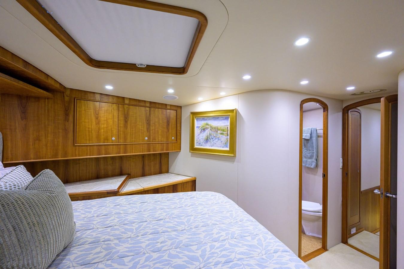 a bedroom with a bed and a mirror aboard GEORGIA GIRL Yacht for Sale