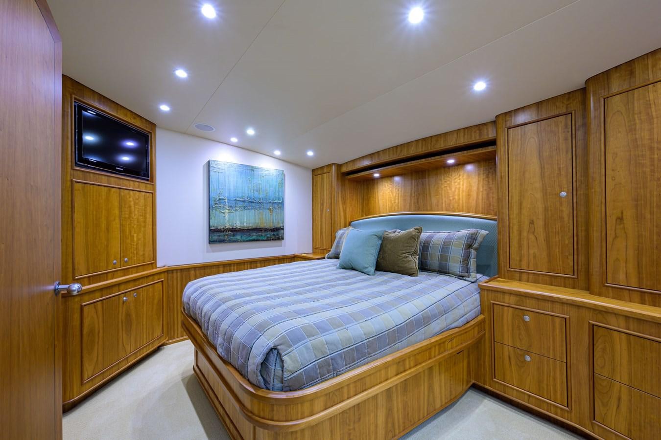 a bedroom with a bed and a television aboard GEORGIA GIRL Yacht for Sale