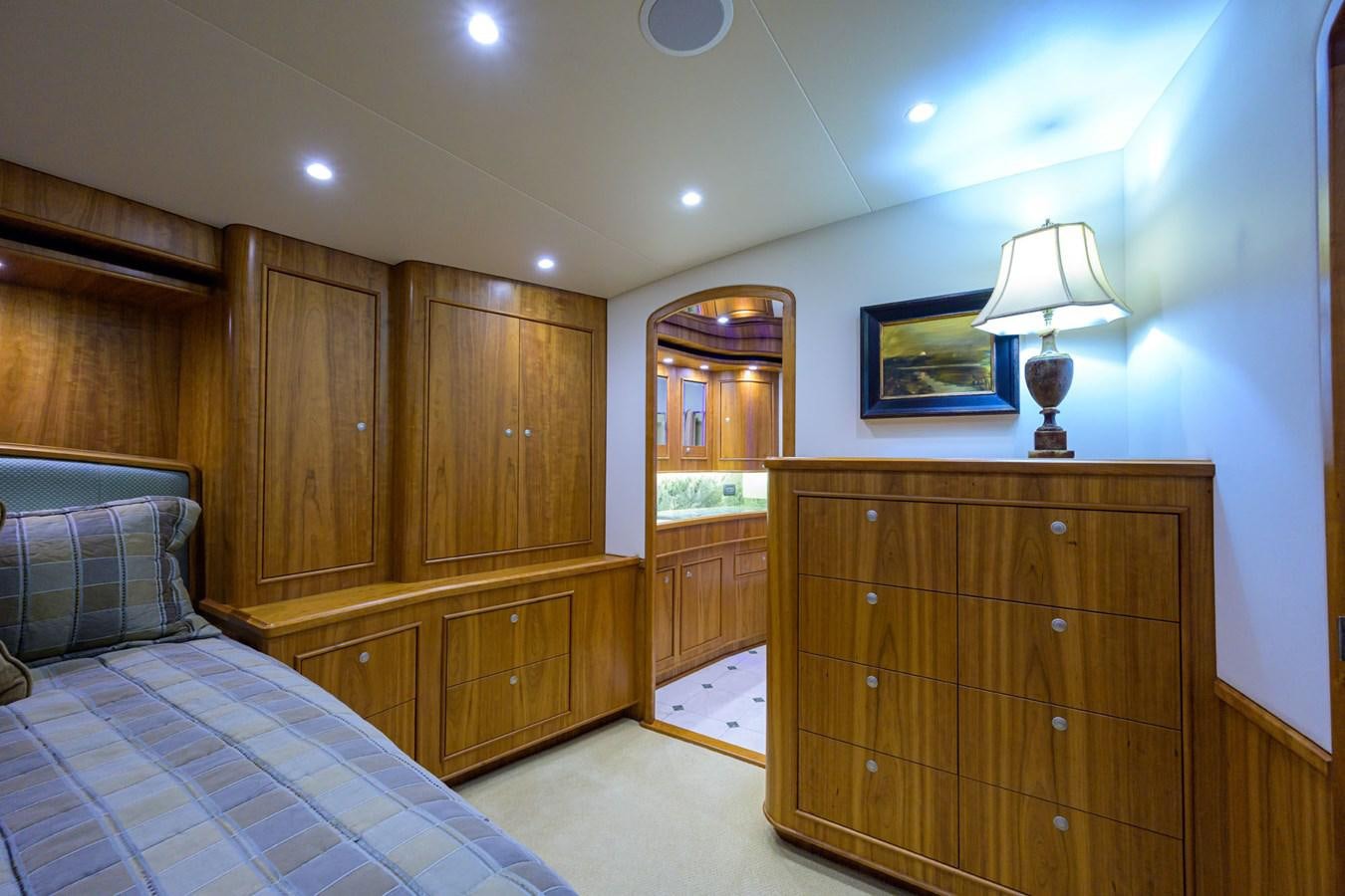 a bedroom with a bed and a dresser aboard GEORGIA GIRL Yacht for Sale