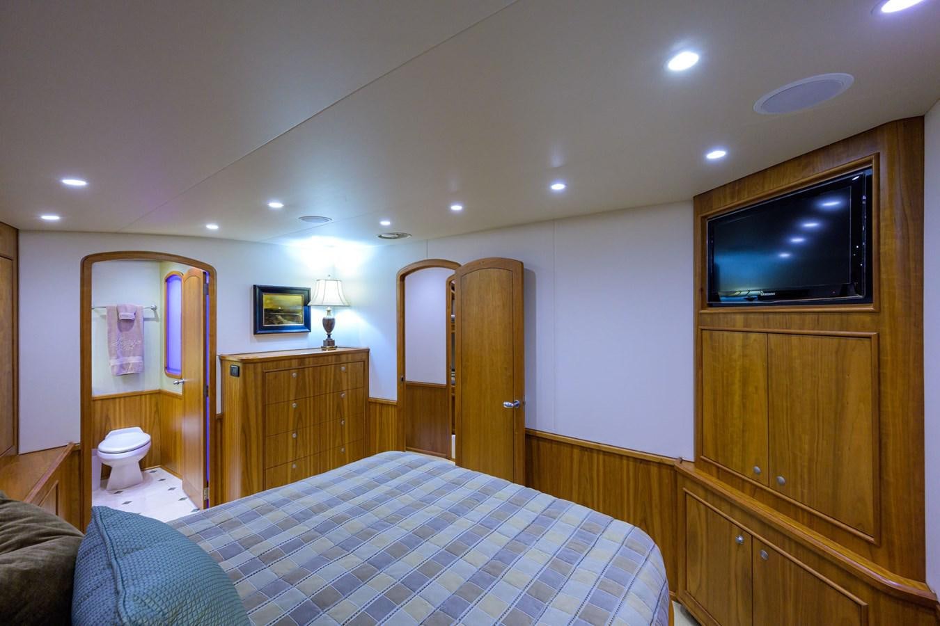 a bedroom with a bed and a television aboard GEORGIA GIRL Yacht for Sale