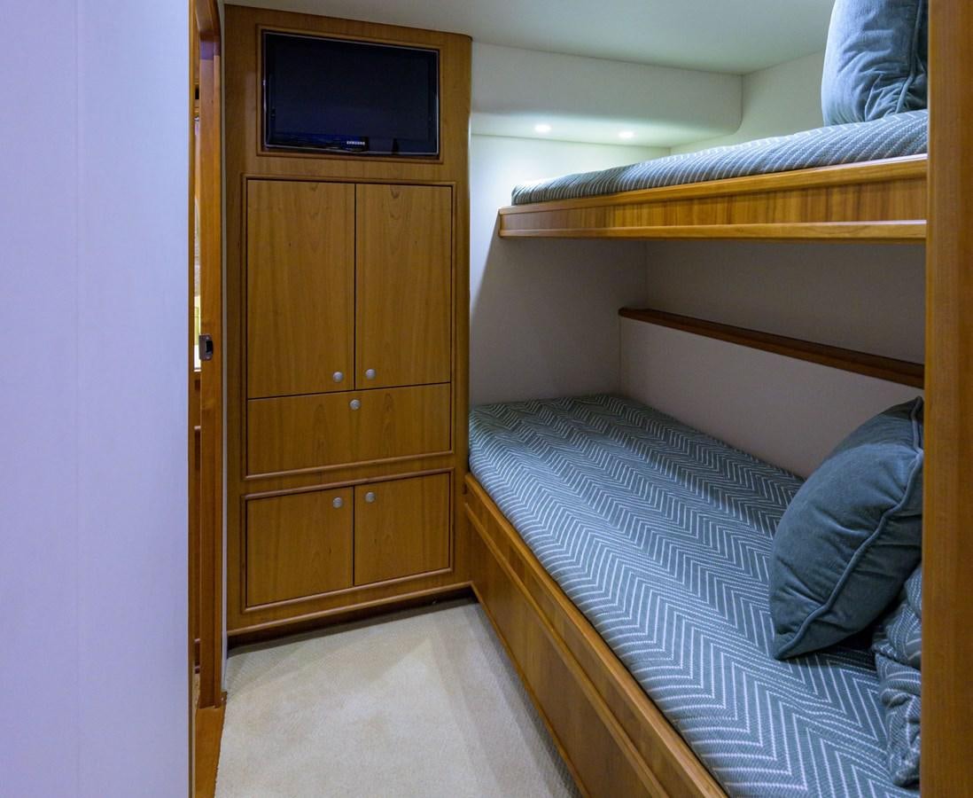a room with a bed and a television aboard GEORGIA GIRL Yacht for Sale