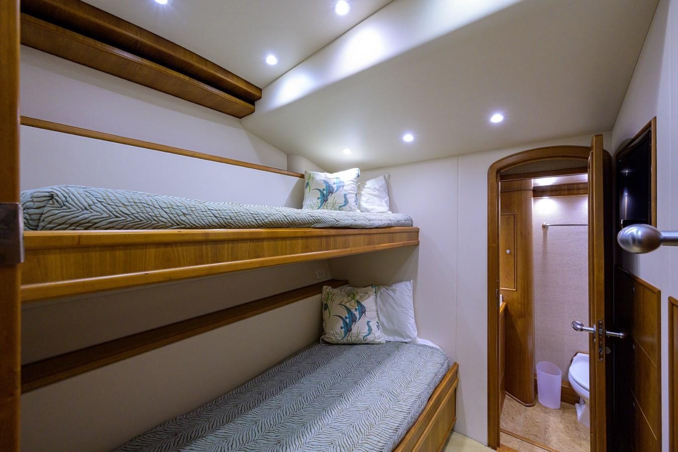 a bedroom with a bed and a closet aboard GEORGIA GIRL Yacht for Sale