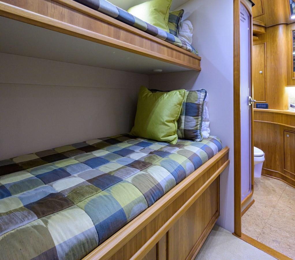 a bed with a blue and green comforter aboard GEORGIA GIRL Yacht for Sale