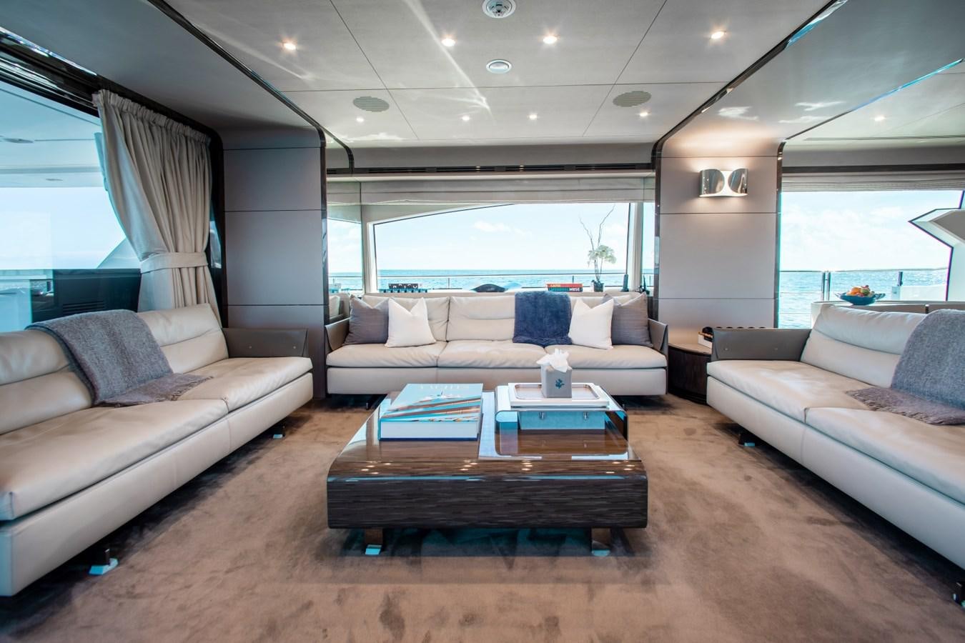 a living room with a couch and a coffee table aboard INDIGO Yacht for Sale