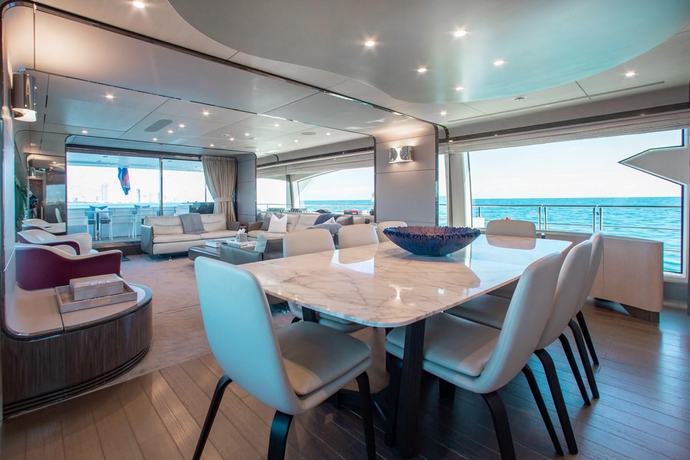 a large room with a table and chairs aboard INDIGO Yacht for Sale