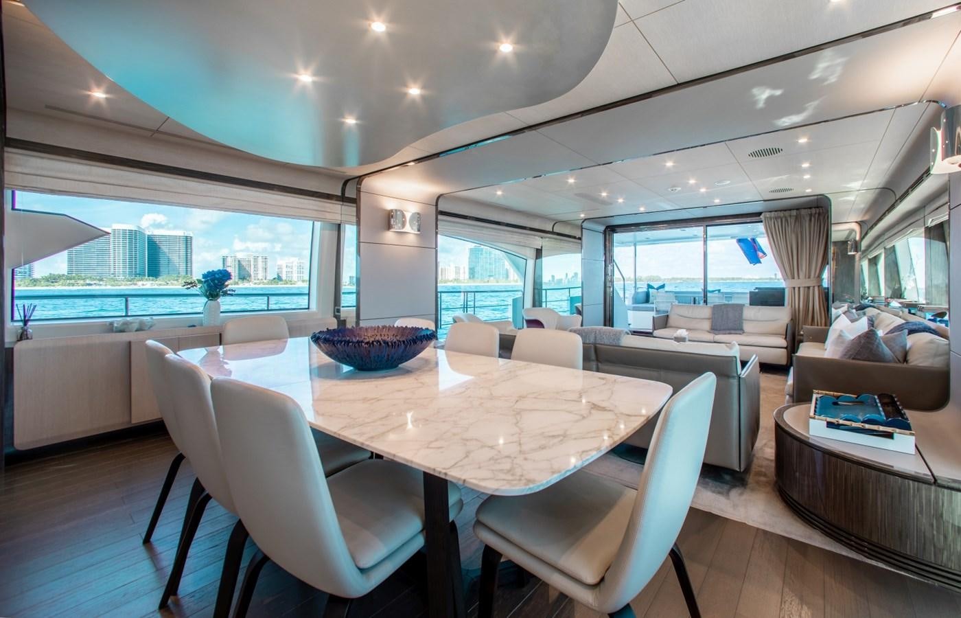 a room with a table chairs and a large window aboard INDIGO Yacht for Sale