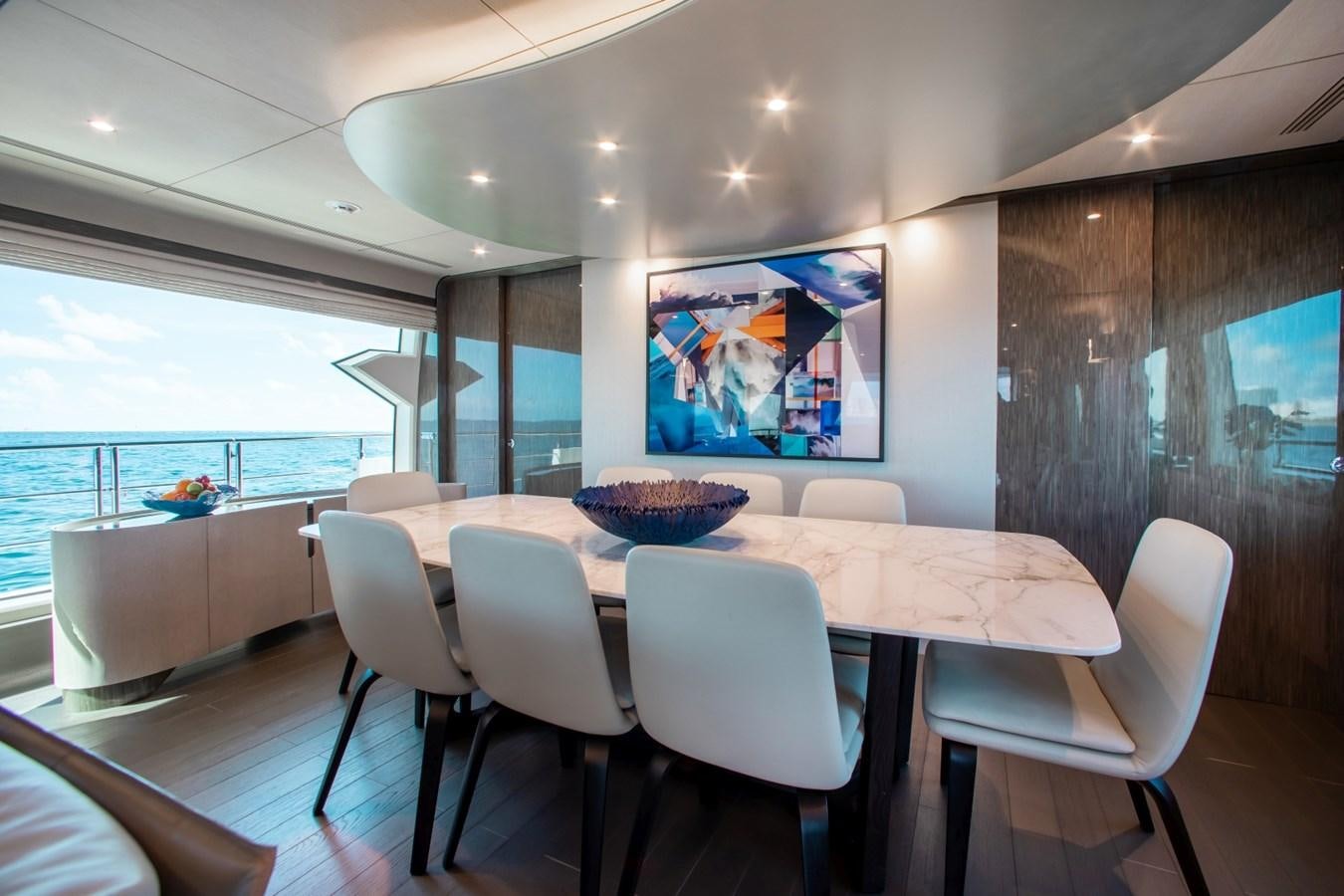 a large modern kitchen with a large table and chairs aboard INDIGO Yacht for Sale