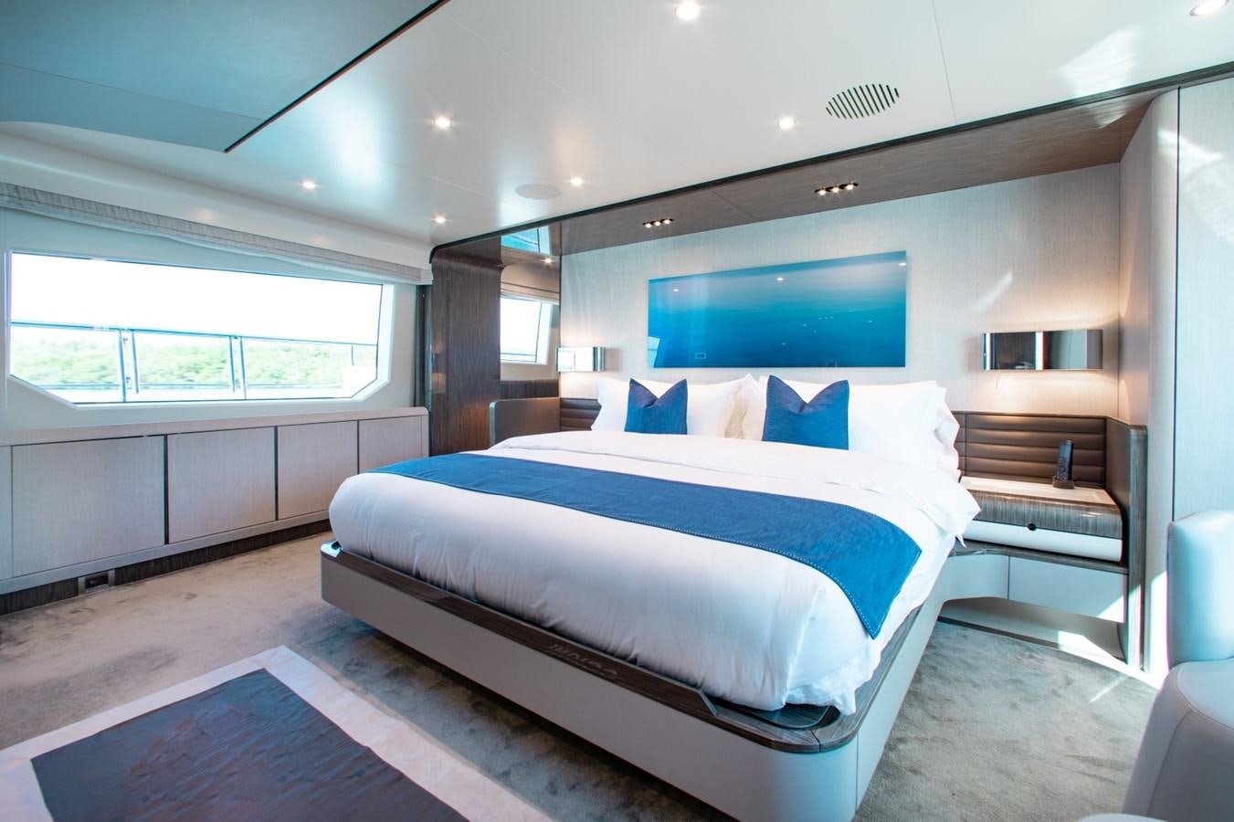 a large bed in a room aboard INDIGO Yacht for Sale