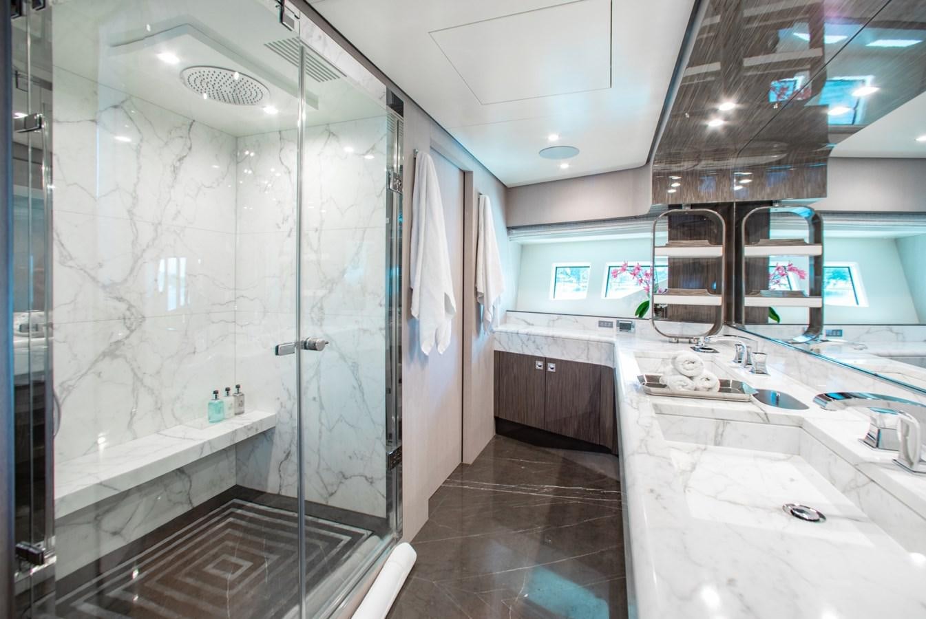 a bathroom with a glass shower aboard INDIGO Yacht for Sale
