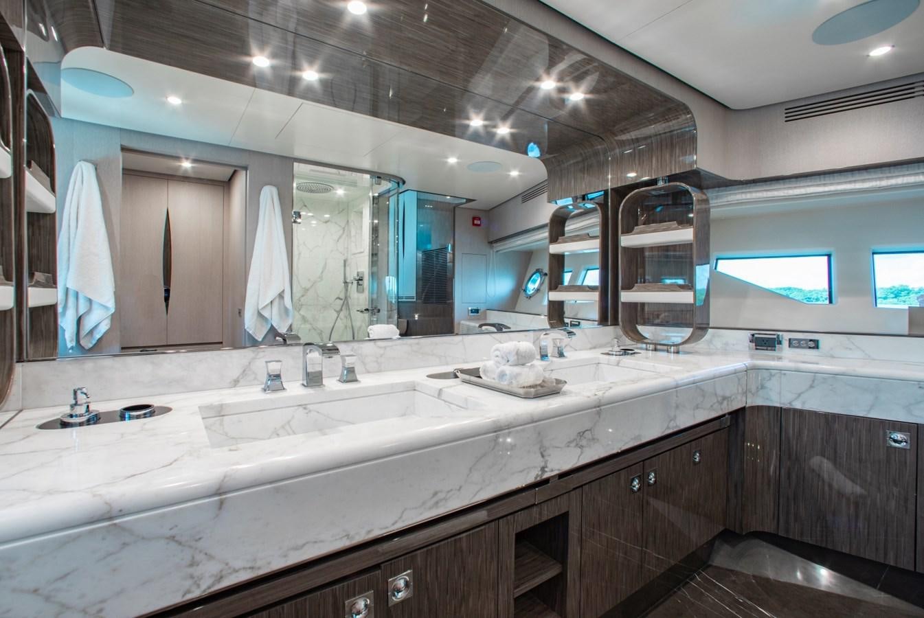 a large bathroom with a large mirror aboard INDIGO Yacht for Sale