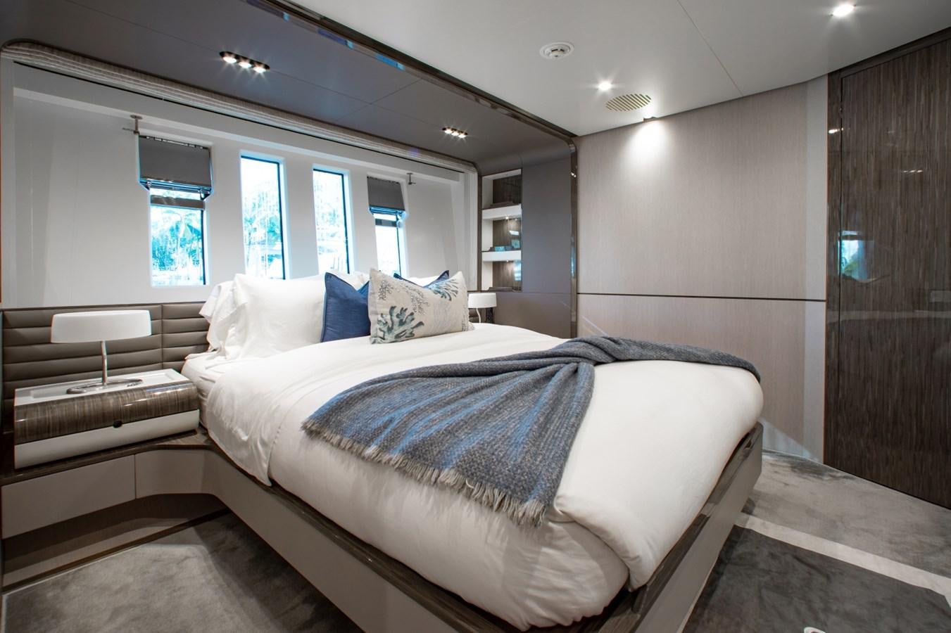 a room with a bed and a wood door aboard INDIGO Yacht for Sale
