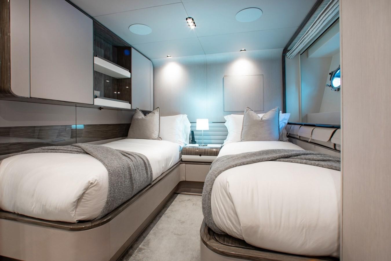 a room with two beds aboard INDIGO Yacht for Sale