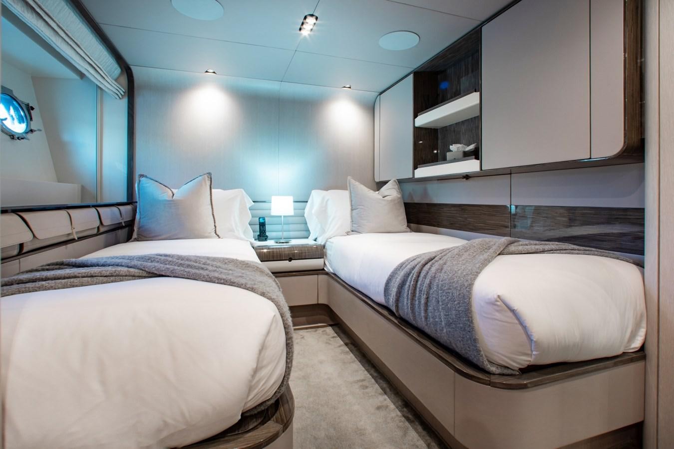 a room with two beds aboard INDIGO Yacht for Sale