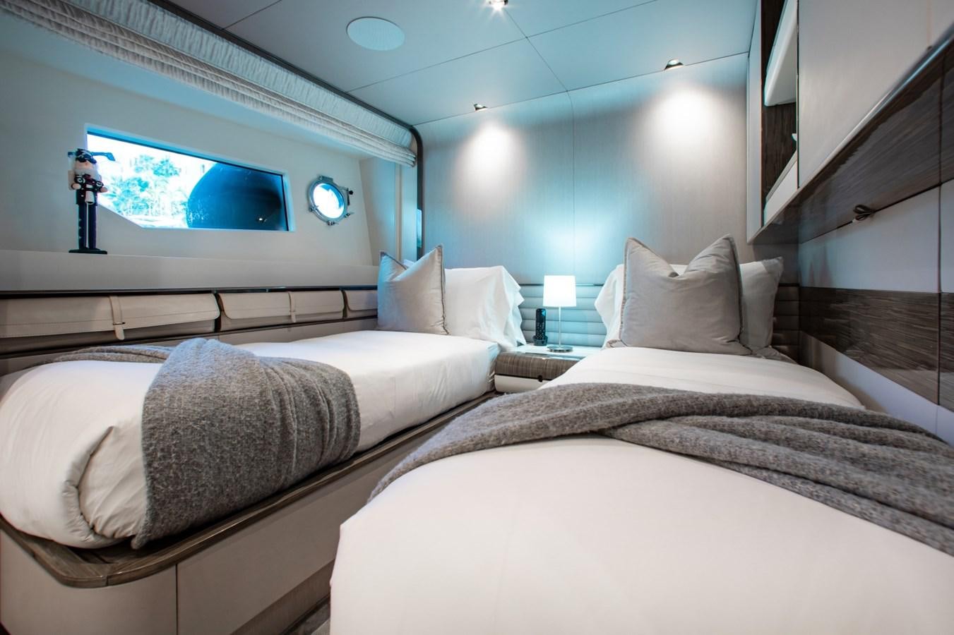 a room with two beds aboard INDIGO Yacht for Sale